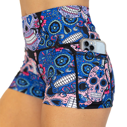side pocket view of blue, pink and teal sugar skull pattern on 2.5" shorts