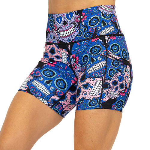 front view of blue, pink and teal sugar skull pattern on 5" shorts