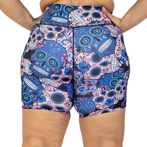 back view of blue, pink and teal sugar skull pattern on 7" shorts