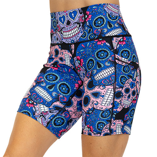 front view of blue, pink and teal sugar skull pattern on 7" shorts