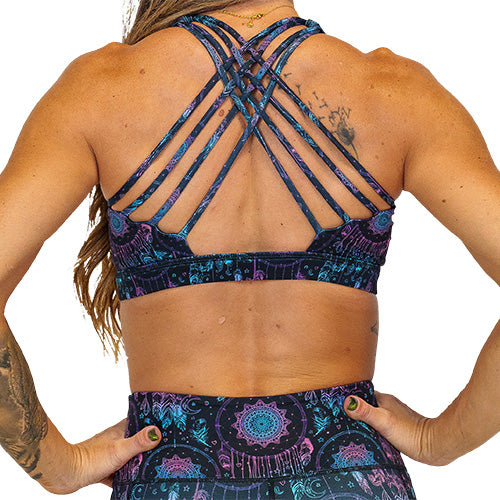 back view of butterfly back strap design on the pink, purple and blue dream catcher print sports bra