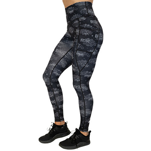 side view of full length black leggings with comic book style action bubbles that say "badass", "fierce" and "dedication"