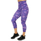 front view of capri length purple leggings with comic book style action bubbles that say "badass", "fierce" and "dedication"