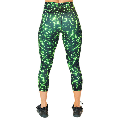 back view of capri length lime green and black dot print leggings