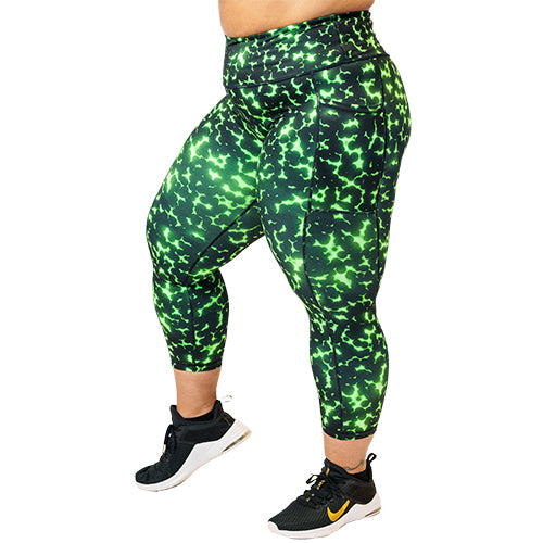 side view of capri length lime green and black dot print leggings