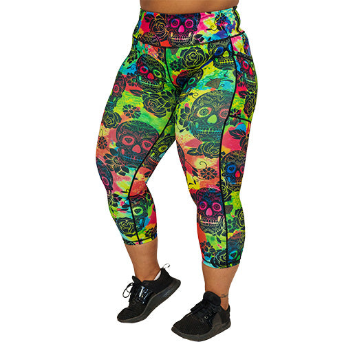 front view of capri length colorful tie dye leggings with black skull pattern