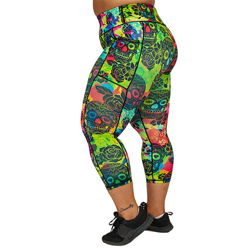 side view of capri length colorful tie dye leggings with black skull pattern
