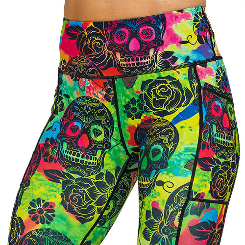 close up view of colorful tie dye leggings with black skull pattern