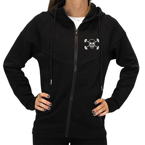 Photo of the side of a model showing the zipper pockets on the black zip up sweatshirt and the CVG skull logo on the top left of the sweatshirt