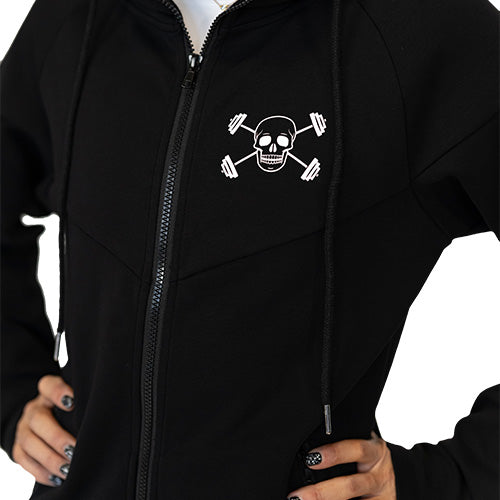 Close up photo of a model wearing a black zip up sweatshirt with the CVG skull logo on the top left corner
