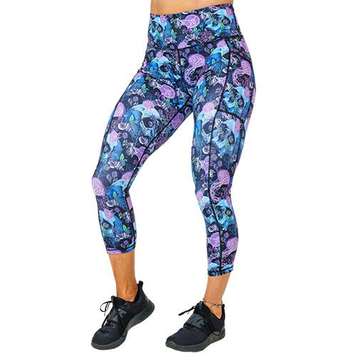 front view of capri length purple jelly fish and blue skull print leggings