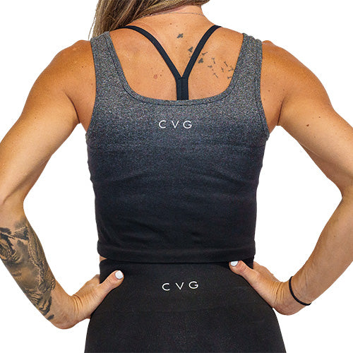 Photo of the back of a model wearing a black ombre crop top with the CVG logo at the top