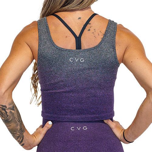 Photo of the back of a model wearing a purple ombre crop top with the CVG logo at the top
