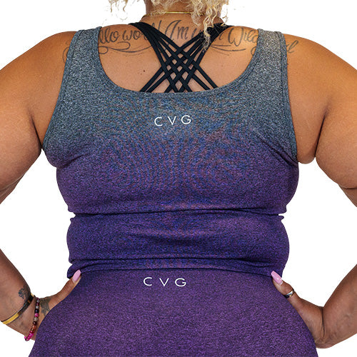 Photo of the back of a model wearing a purple ombre crop top with the CVG logo at the top