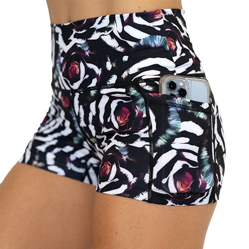 close up pocket view of blue, pink, white petal design on black 2.5" shorts