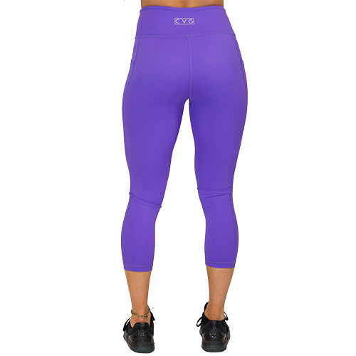 back view of capri length solid purple leggings