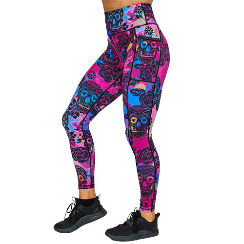 side view of full length purple, pink and blue tie dye leggings with black skull and rose pattern