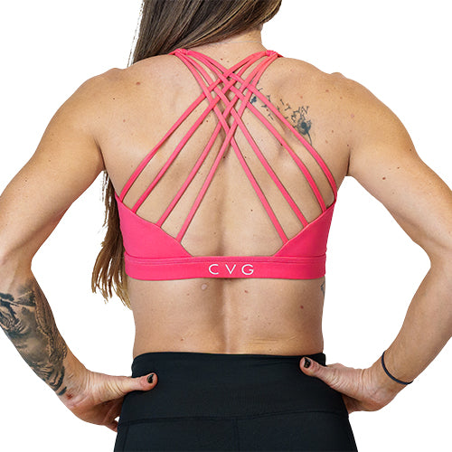 back view of butterfly back strap design on the solid pink sports bra