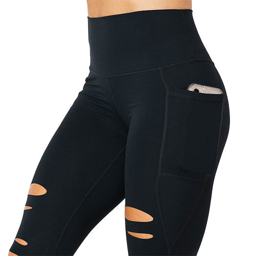 Close up photo of the black tear it up leggings with a phone in the front pocket. These have rips in the leggings 