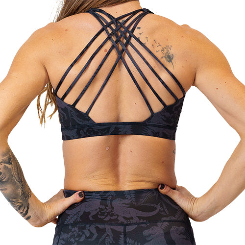 back view of black on black dinosaur patterned sports bra