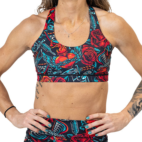 front view of old fashioned tattoo inspired print sports bra
