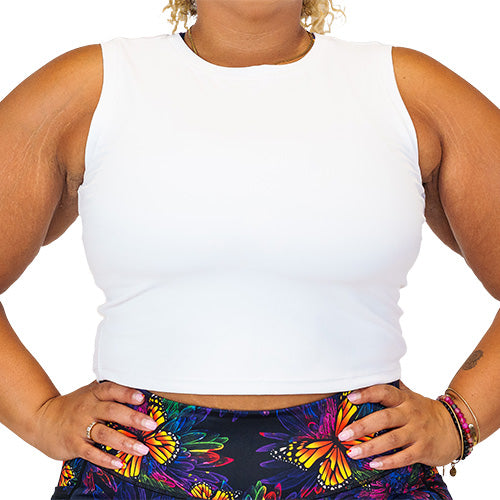 Close up photo of a model wearing a white fitted crop top