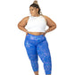 full body photo of model wearing blue and purple holographic leggings and white fitted crop top