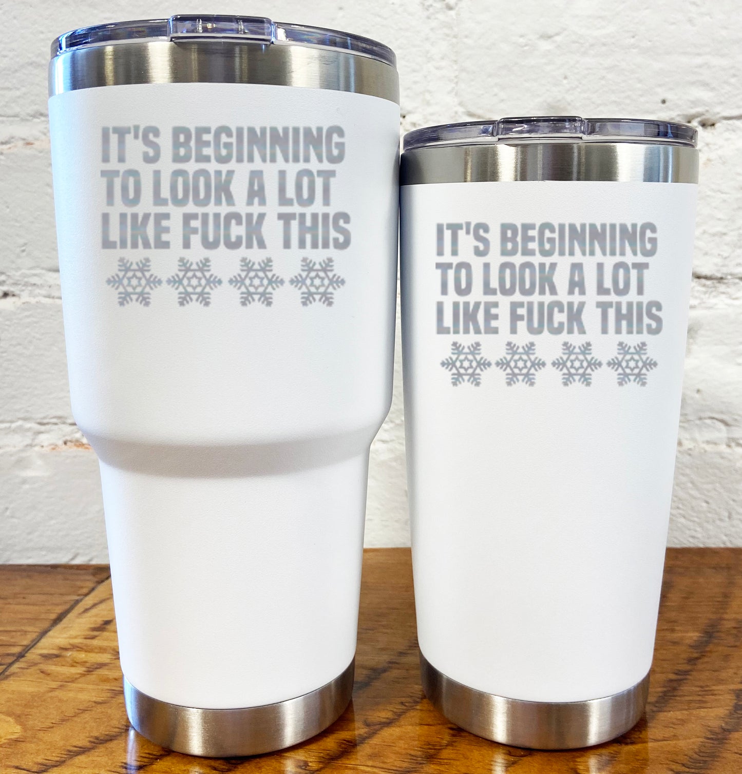 30oz and 20oz white tumblers with silver saying "it's beginning to look a lot like fuck this" with snowflakes underneath