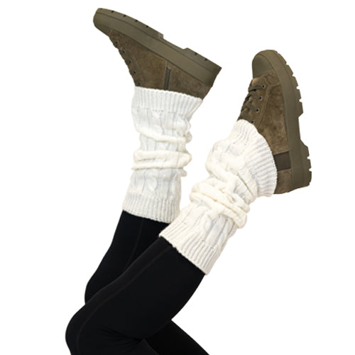 Close up photo of a model wearing white leg warmers over her boots