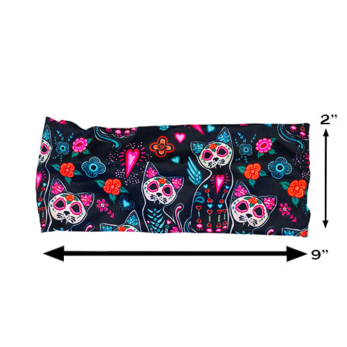 headband with a colorful cat skull and floral design measured at 2 by 9 inches