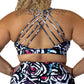 back view of butterfly back strap design on white, black, pink and blue petals print sports bra
