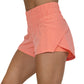 side view of solid pink peach colored running shorts