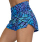 side view of purple and blue stained glass print running shorts