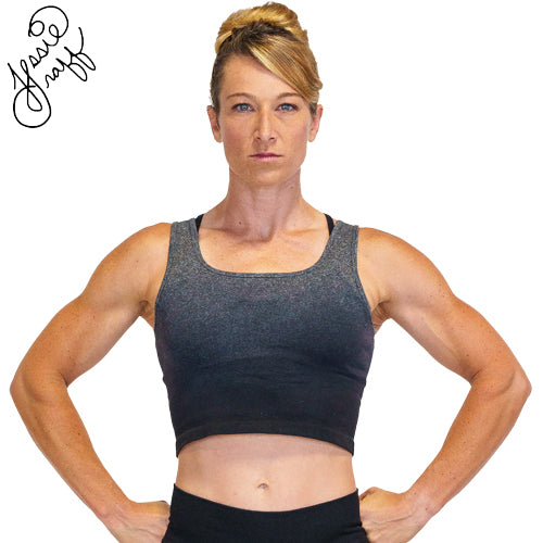 Photo of ninja warrior, Jessie Graff, wearing a black ombre crop top. Her signature is in the top left of the photo