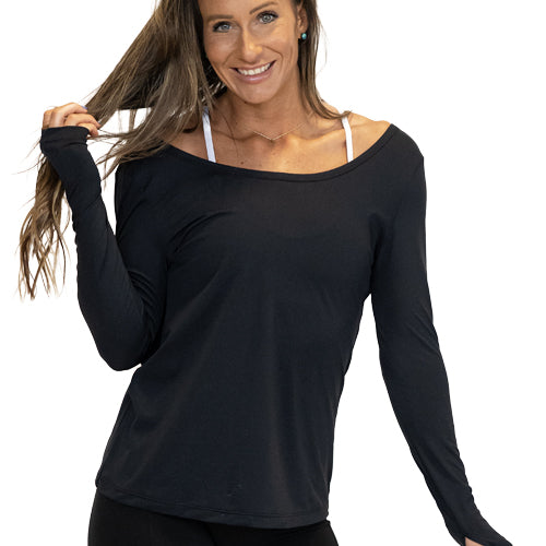 front view of the black solid long sleeve shirt off the shoulders of the model 