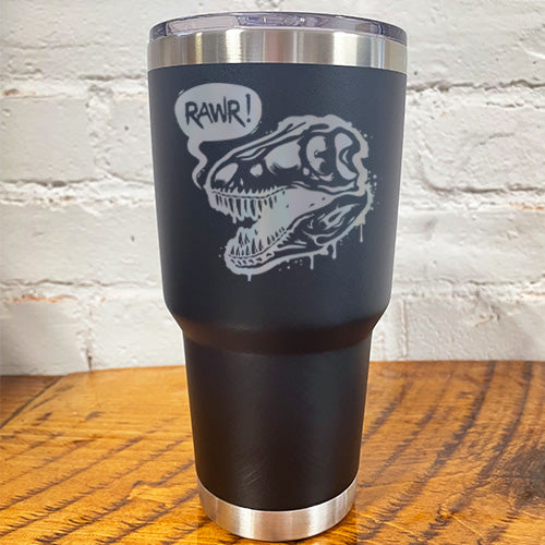 black 30oz tumbler with silver dino skull with speech bubble saying "rawr!"