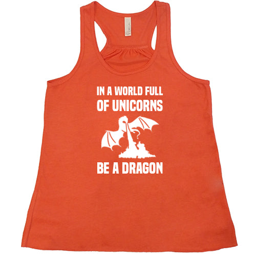 coral racerback shirt with the saying "In A World Full Of Unicorns Be A Dragon" on it in white