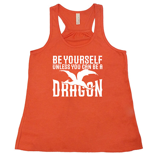 coral racerback shirt with the saying "Be Yourself Unless You Can Be A Dragon" on it in white