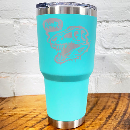 30oz teal blue tumbler with silver dino skull with speech bubble saying "rawr!"