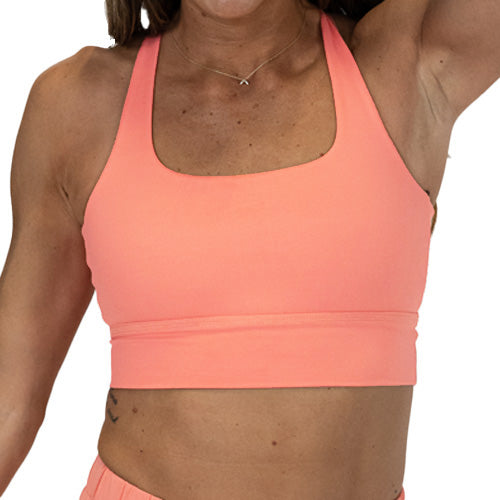 front view of solid pink peach colored longline bra