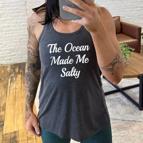 Model wearing a grey racerback tank with the saying "The ocean made me salty" in white
