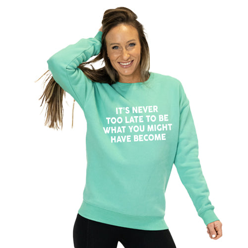front view of spearmint crew neck with saying "it's never too late to be what you might have become" in white