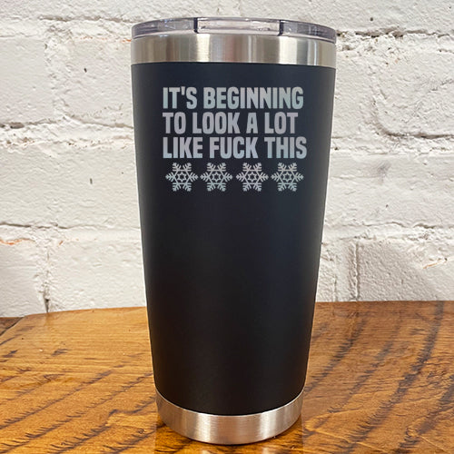 20oz black tumbler with silver saying "it's beginning to look a lot like fuck this" with snowflakes underneath