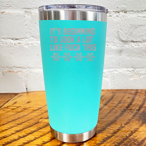 20oz teal blue tumbler with silver saying "it's beginning to look a lot like fuck this" with snowflakes underneath