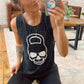 model wearing a black marble muscle tank with a kettlebell skull design on the front