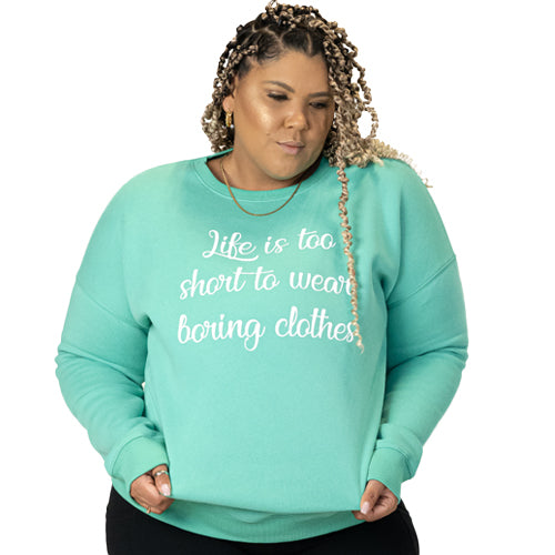 front view of spearmint crew neck with saying "life is too short to wear boring clothes" in white