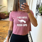 Model wearing a mauve colored cropped tee with a dinosaur and the saying "T-rex hates push-ups" on the front