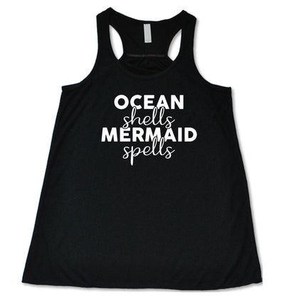 black racerback tank with the saying "ocean shells mermaid spells" in white in the center