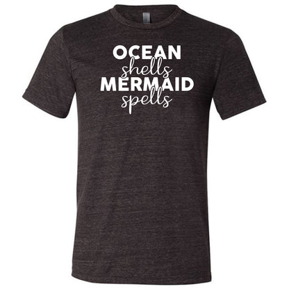black unisex tee with the saying "ocean shells mermaid spells" in white in the center