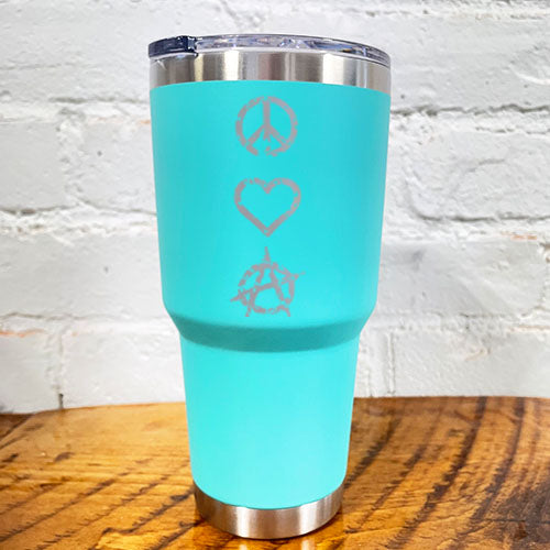 silver peace sign, heart and anarchy symbol on a teal blue 30oz tumbler